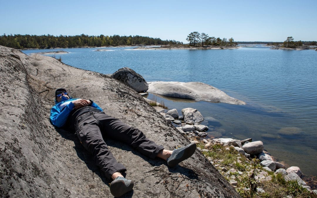 Swimrunner realxing on a rock in the Stockholm archipelago