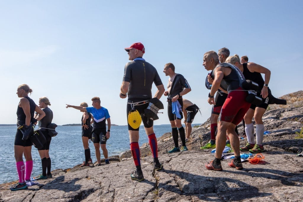 Swimrun group on rock in Stockholm archipelago